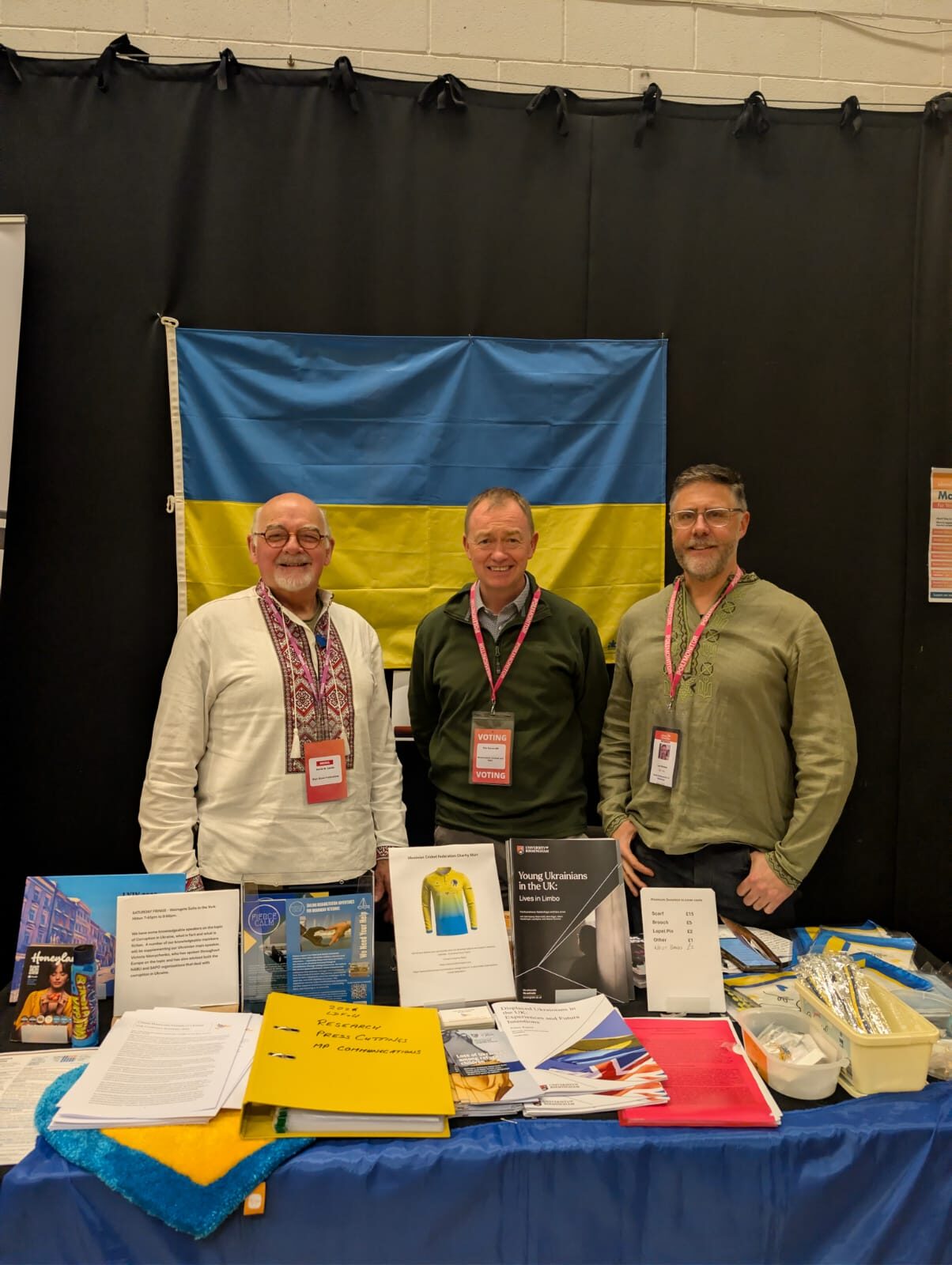 Fierce Calm representatives standing in front of a Ukrainian flag