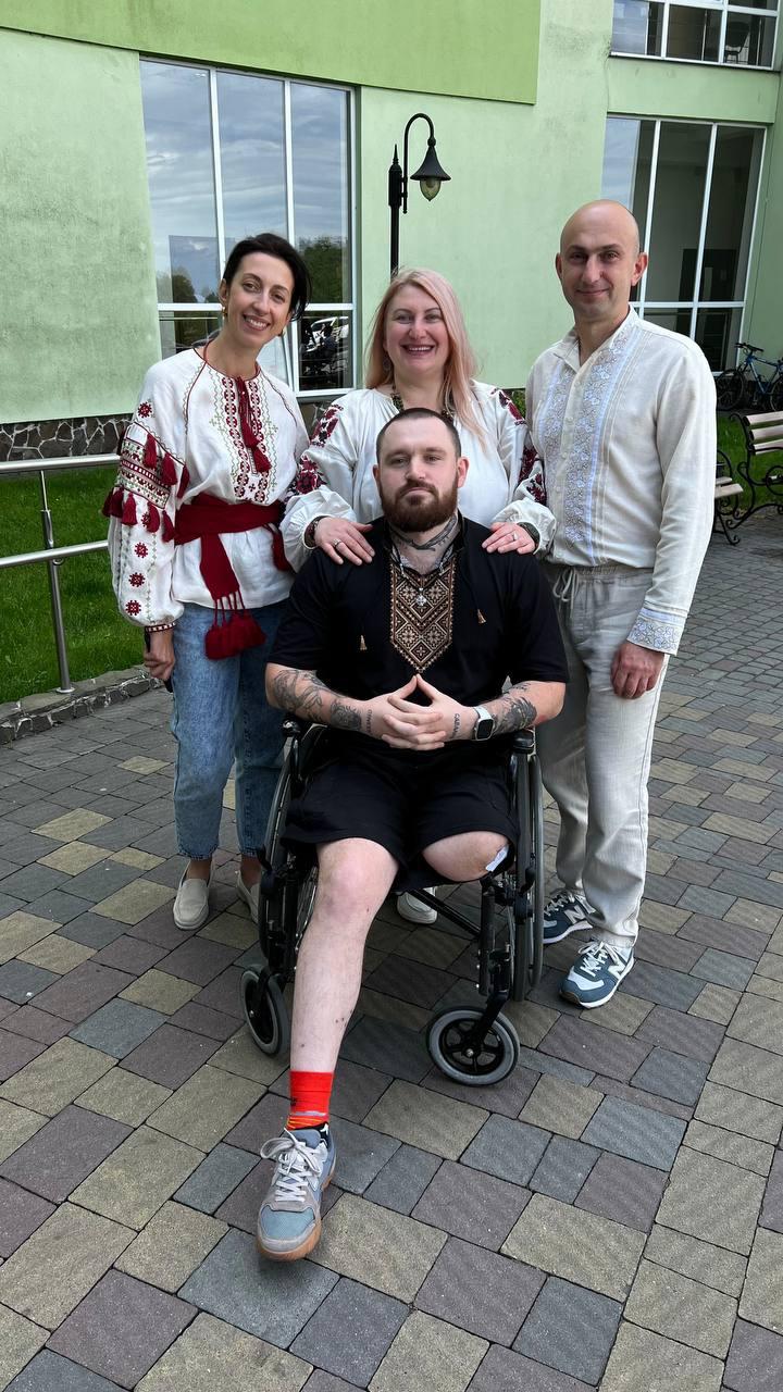 A Fierce Calm team and veteran in traditional Ukrainian shirts outside a rehabilitation centre