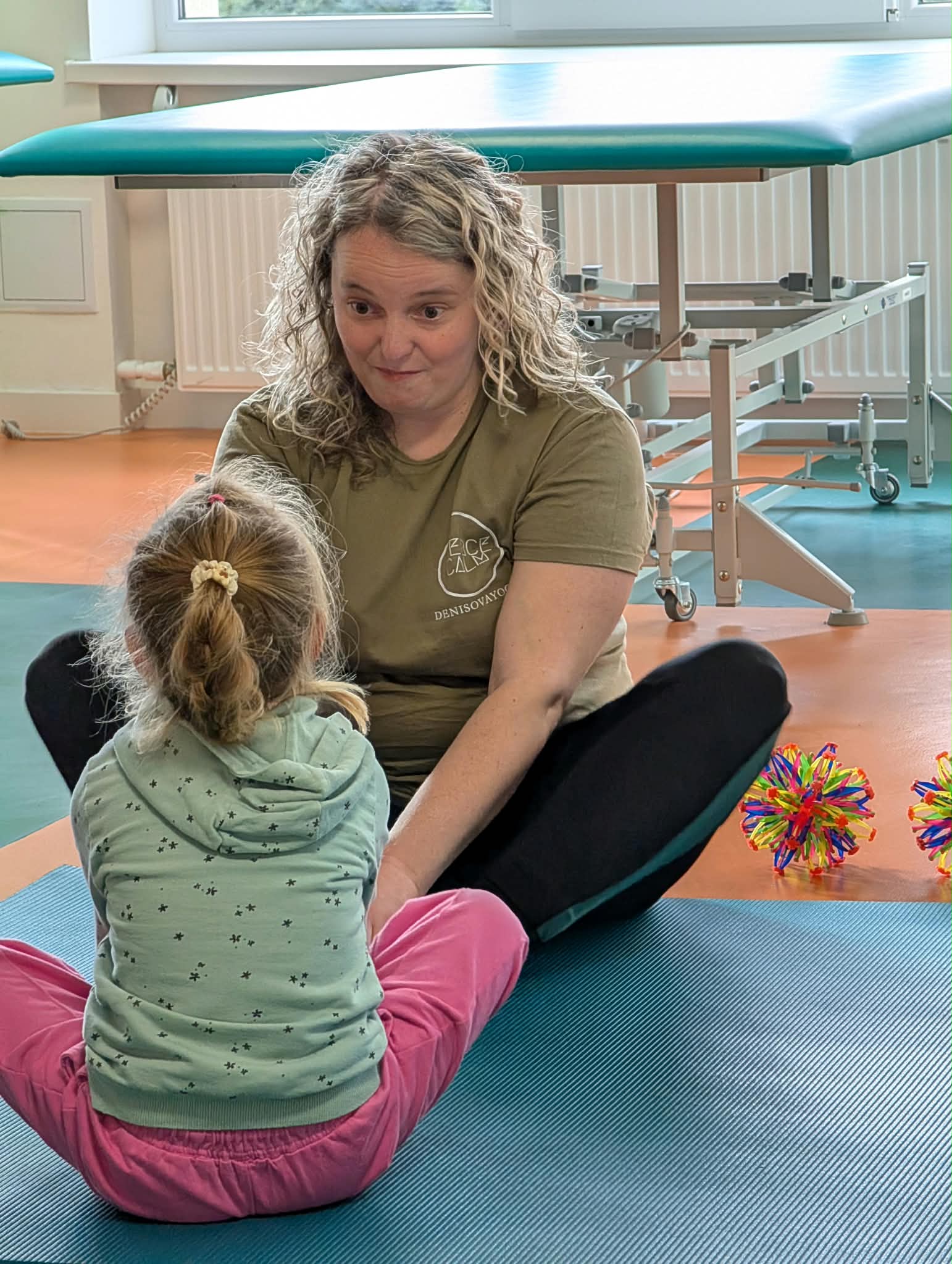 A Fierce Calm practitioner sitting with a child during a therapy session