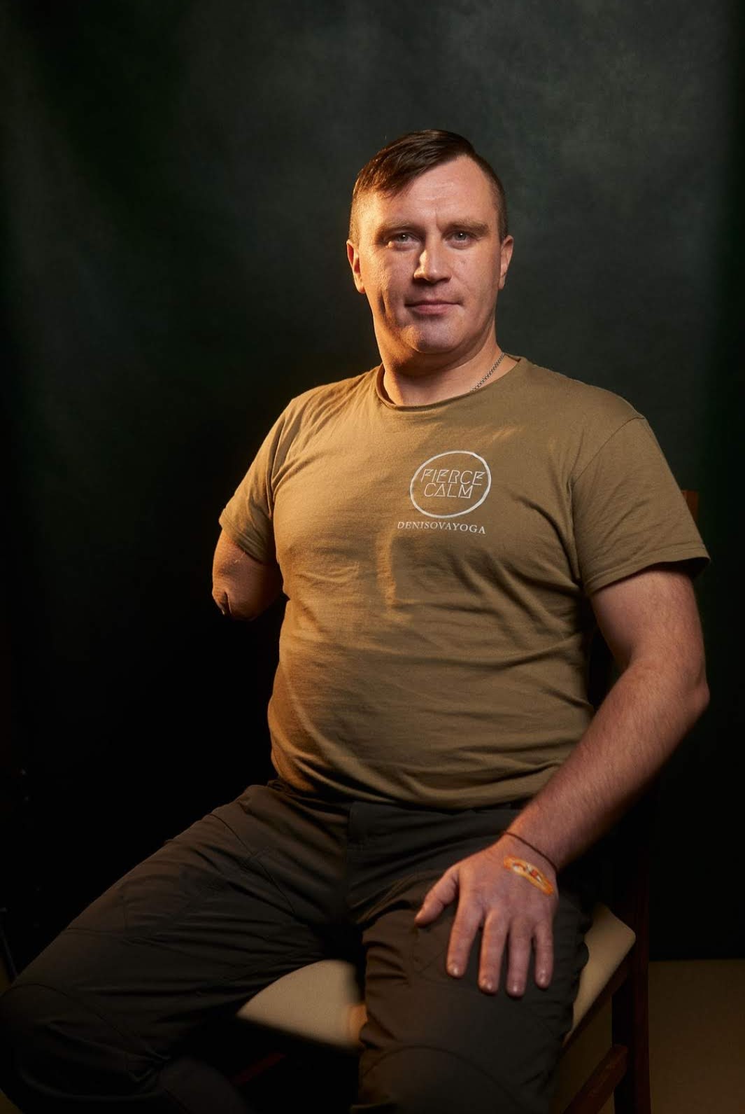 A veteran seated for a portrait in a Fierce Calm shirt