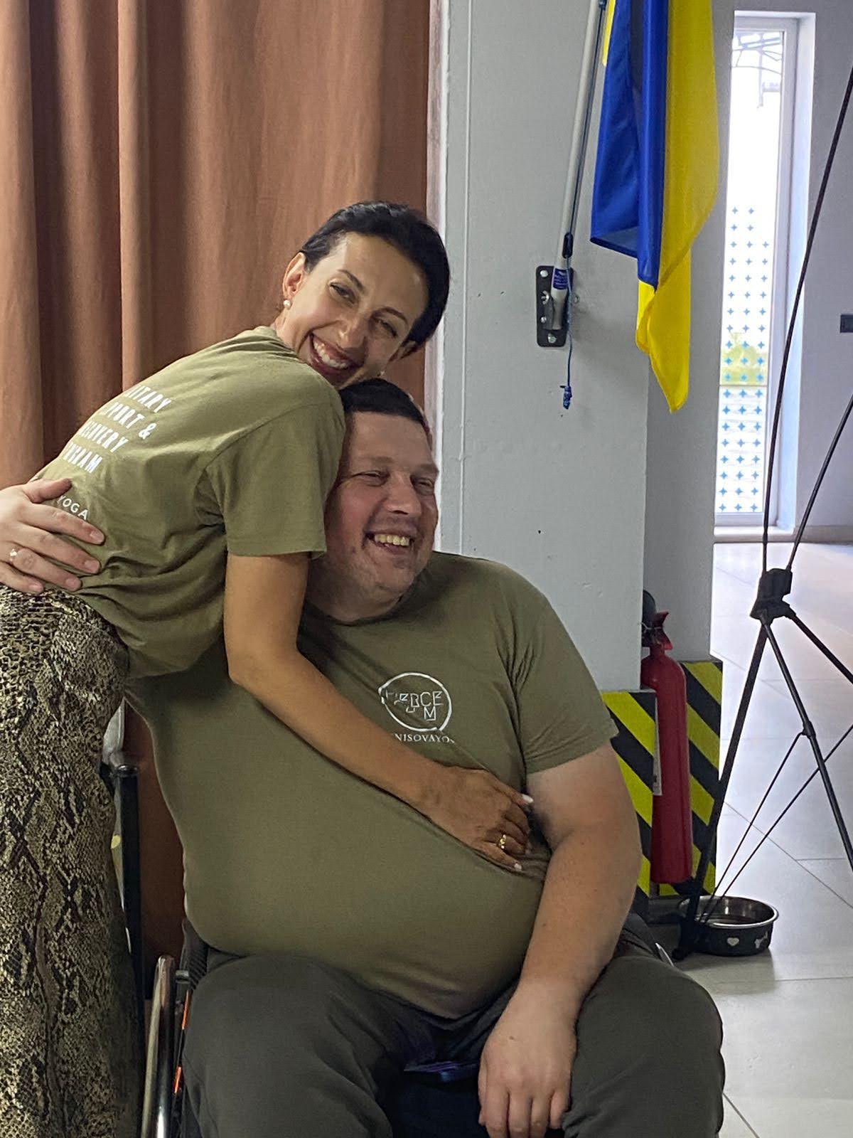 A woman embracing a man in a rehabilitation space
