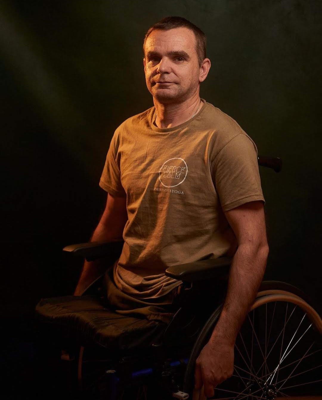 A veteran seated in a wheelchair wearing a Fierce Calm shirt