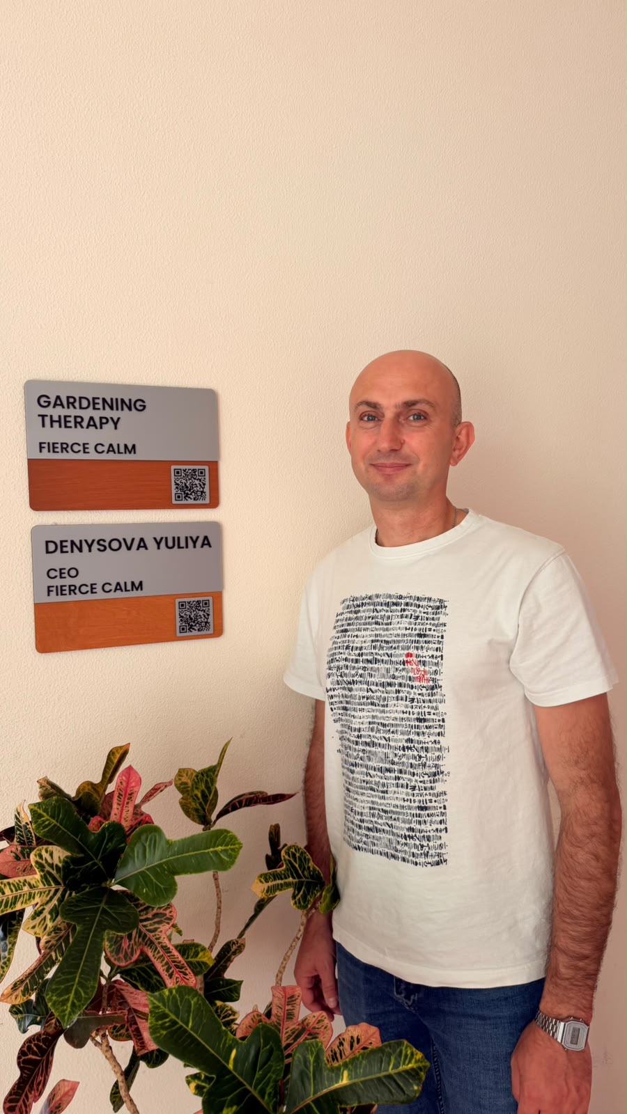 Dr Lee Watson beside plants in Fierce Calm's gardening therapy space